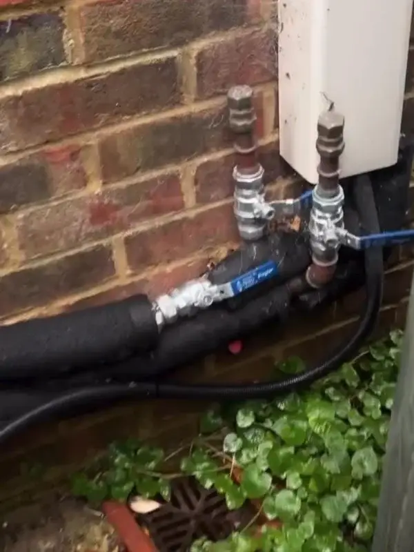 Heat pump pipework, valves and insulation where it enters the house